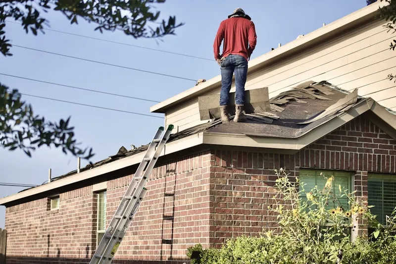 Professional roofer working on a residential roof in Lake Sarasota